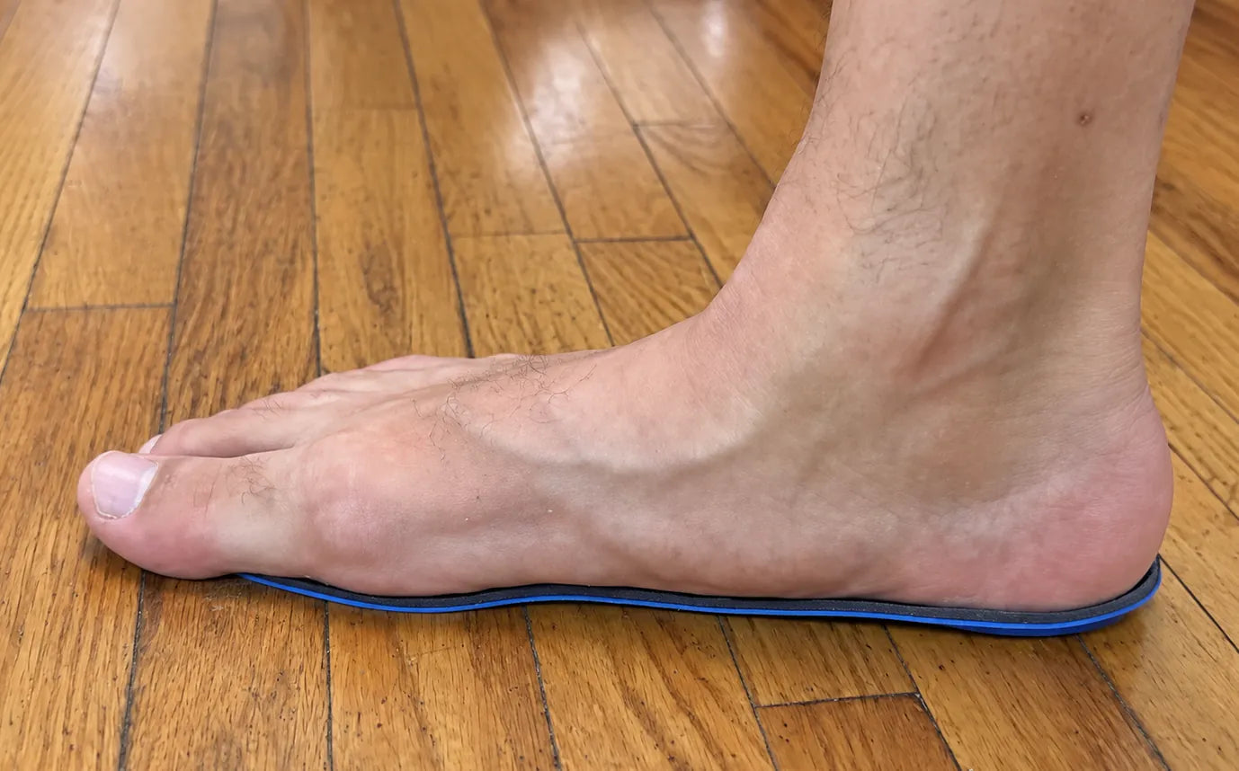 A soft arch support insole flattened after weeks of use